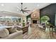 Comfortable living room with stone fireplace, vaulted ceilings, and large windows overlooking the pool at 506 Crystal Grove Blvd, Lutz, FL 33548