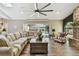 Bright living room features wood-look floors, neutral paint, fireplace and access to the screened-in pool area at 506 Crystal Grove Blvd, Lutz, FL 33548