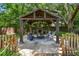 Inviting outdoor area with a stone fireplace, comfortable seating, and a charming backyard setting at 506 Crystal Grove Blvd, Lutz, FL 33548