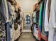 Walk-in closet with custom shelving and hanging space, illuminated by natural light at 506 Crystal Grove Blvd, Lutz, FL 33548