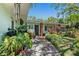 Welcoming exterior with lush tropical plants, and a charming brick pathway to the front entrance at 5127 29Th S Ave, Gulfport, FL 33707