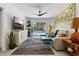 Bright living room leads to backyard pool area with a unique ceiling fan and eye-catching wall art at 5127 29Th S Ave, Gulfport, FL 33707