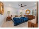 Main bedroom features contemporary decor, a ceiling fan, and shutters for natural light control at 5127 29Th S Ave, Gulfport, FL 33707