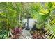 Secluded outdoor shower surrounded by lush tropical plants, offering a private and refreshing experience at 5127 29Th S Ave, Gulfport, FL 33707
