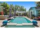Backyard pool area surrounded by tropical landscaping, pavers, lounge furniture, and a cabana at 5127 29Th S Ave, Gulfport, FL 33707