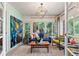 Inviting sunroom features comfortable seating, stylish decor, and lush views of the surrounding greenery at 5127 29Th S Ave, Gulfport, FL 33707