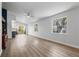 Open concept living room boasts wood floors, lots of natural light, ceiling fan and sliding door access to backyard at 5413 N Park Pl, Tampa, FL 33603
