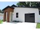 Contemporary home boasts a sleek garage door, modern lighting and a minimalist, landscaped yard at 5518 Newton S Ave, Gulfport, FL 33707