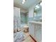 Cozy bathroom featuring a tiled shower, vanity, and tiled flooring at 5876 21St N St # 10, St Petersburg, FL 33714