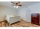 Comfortable bedroom featuring a ceiling fan, closet, and wood-look floors at 5876 21St N St # 10, St Petersburg, FL 33714