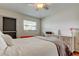 Bright bedroom features a ceiling fan, a window, and a lovely white dresser at 5876 21St N St # 10, St Petersburg, FL 33714
