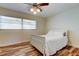 Charming bedroom featuring a full bed, ceiling fan, and beautiful wood-look flooring at 5876 21St N St # 10, St Petersburg, FL 33714