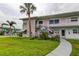 Charming two-story condo building with landscaped front yard and classic Florida palm trees at 5876 21St N St # 10, St Petersburg, FL 33714