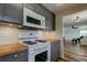 Modern kitchen with stainless steel appliances, butcher block counters, and a view to the living area at 5876 21St N St # 10, St Petersburg, FL 33714