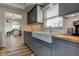 Galley kitchen featuring gray cabinets, wood counters, modern appliances, and an open layout to living room at 5876 21St N St # 10, St Petersburg, FL 33714