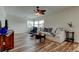 Bright living room with large windows, comfortable sofa, wood-look floors, and a ceiling fan at 5876 21St N St # 10, St Petersburg, FL 33714