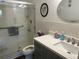 A renovated bathroom features a walk-in shower and updated vanity at 5990 Terrace Park N Dr # 109, St Petersburg, FL 33709