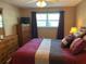 Cozy bedroom with a dresser and natural light at 5990 Terrace Park N Dr # 109, St Petersburg, FL 33709