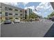 Well-maintained building with ample parking, trees, and an American flag flying in the breeze at 5990 Terrace Park N Dr # 109, St Petersburg, FL 33709