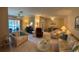 Spacious living room with comfortable seating, a desk area, and a dining table at 5990 Terrace Park N Dr # 109, St Petersburg, FL 33709