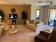 Cozy living room with plush seating, a glass coffee table, and a sliding door to the outside at 5990 Terrace Park N Dr # 109, St Petersburg, FL 33709