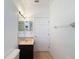 Compact bathroom features a single sink vanity with tan marble countertop and a standard toilet at 6208 Bridgevista Dr, Lithia, FL 33547