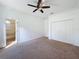 Bedroom featuring carpet, ceiling fan, white walls, and access to a bathroom at 6208 Bridgevista Dr, Lithia, FL 33547
