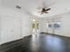 Bright bedroom with dark wood floors, ceiling fan, and sliding glass doors leading to the pool area at 6208 Bridgevista Dr, Lithia, FL 33547
