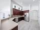 Open kitchen with stainless steel appliances, dark cabinets, and a breakfast bar at 6208 Bridgevista Dr, Lithia, FL 33547
