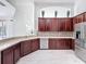 Stylish kitchen with stainless appliances, dark wood cabinets, and tile backsplash at 6208 Bridgevista Dr, Lithia, FL 33547