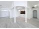 Spacious and bright open-concept living area with decorative columns and stylish lighting at 6208 Bridgevista Dr, Lithia, FL 33547