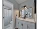 Bathroom with a white vanity, modern fixtures, and a shower-tub combination with a floral shower curtain at 6592 Mango S Ave, St Petersburg, FL 33707