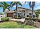 Charming single Gathering home featuring a beautifully landscaped yard with mature palm trees at 6592 Mango S Ave, St Petersburg, FL 33707