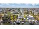 This aerial view shows a home with canal frontage, a private boat dock, and lift at 6801 Clark St, Hudson, FL 34667