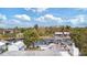 Aerial view shows home, boat dock, and lift plus tiki hut and conversation set on the property at 6801 Clark St, Hudson, FL 34667