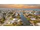 Aerial view of neighborhood showing waterfront homes with canal access leading out to the ocean at 6801 Clark St, Hudson, FL 34667