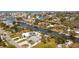 Wide aerial view of canal community with waterfront homes, docks, and boat lifts on a sunny day at 6801 Clark St, Hudson, FL 34667
