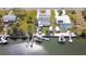 Aerial view showcases a house with waterfront access, boat dock, and manicured landscaping at 6801 Clark St, Hudson, FL 34667