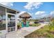 Landscaped backyard with a tiki hut, boat lift, and outdoor seating area perfect for entertainment at 6801 Clark St, Hudson, FL 34667