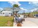 Waterfront backyard featuring a tiki hut, lush landscaping, and cozy outdoor seating area with boat access at 6801 Clark St, Hudson, FL 34667
