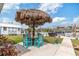 Spacious backyard featuring a tiki hut, outdoor seating, and lush landscaping for relaxing or entertaining at 6801 Clark St, Hudson, FL 34667
