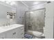 Bathroom featuring a vanity with drawers and cabinets, a framed mirror, and tiled shower with glass door at 6801 Clark St, Hudson, FL 34667