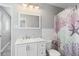 Bathroom with modern vanity, neutral wall color, decorative shower curtain at 6801 Clark St, Hudson, FL 34667
