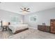 Bedroom with queen bed, ceiling fan, and windows providing natural light at 6801 Clark St, Hudson, FL 34667