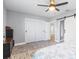 Bedroom featuring sliding closet doors, neutral walls, and modern ceiling fan at 6801 Clark St, Hudson, FL 34667