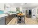 Spacious kitchen featuring modern appliances, grey lower cabinets, white upper cabinets, and center island at 6801 Clark St, Hudson, FL 34667
