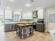 Bright kitchen with stainless steel appliances, center island, and white and grey cabinets at 6801 Clark St, Hudson, FL 34667
