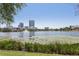 Picturesque lake view with lily pads, city buildings and fountain offering serenity and beauty at 701 Mirror Lake N Dr # 100, St Petersburg, FL 33701