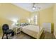 Cozy bedroom with window, ceiling fan, and furniture at 701 Mirror Lake N Dr # 119, St Petersburg, FL 33701