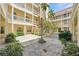 Beautiful courtyard with multiple story balconies and lush landscaping at 701 Mirror Lake N Dr # 119, St Petersburg, FL 33701
